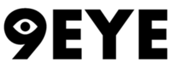 Overhead portrait of a musician lying in darkness beside a small keyboard, surrounded by glowing colorful orb lights in red, teal, and yellow.